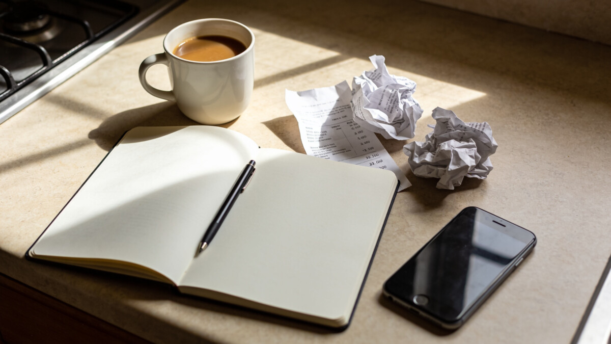 A Budget Is a Living Plan, Not a One-Time Document why your budget fails every month - morning budget planning with notebook and coffee