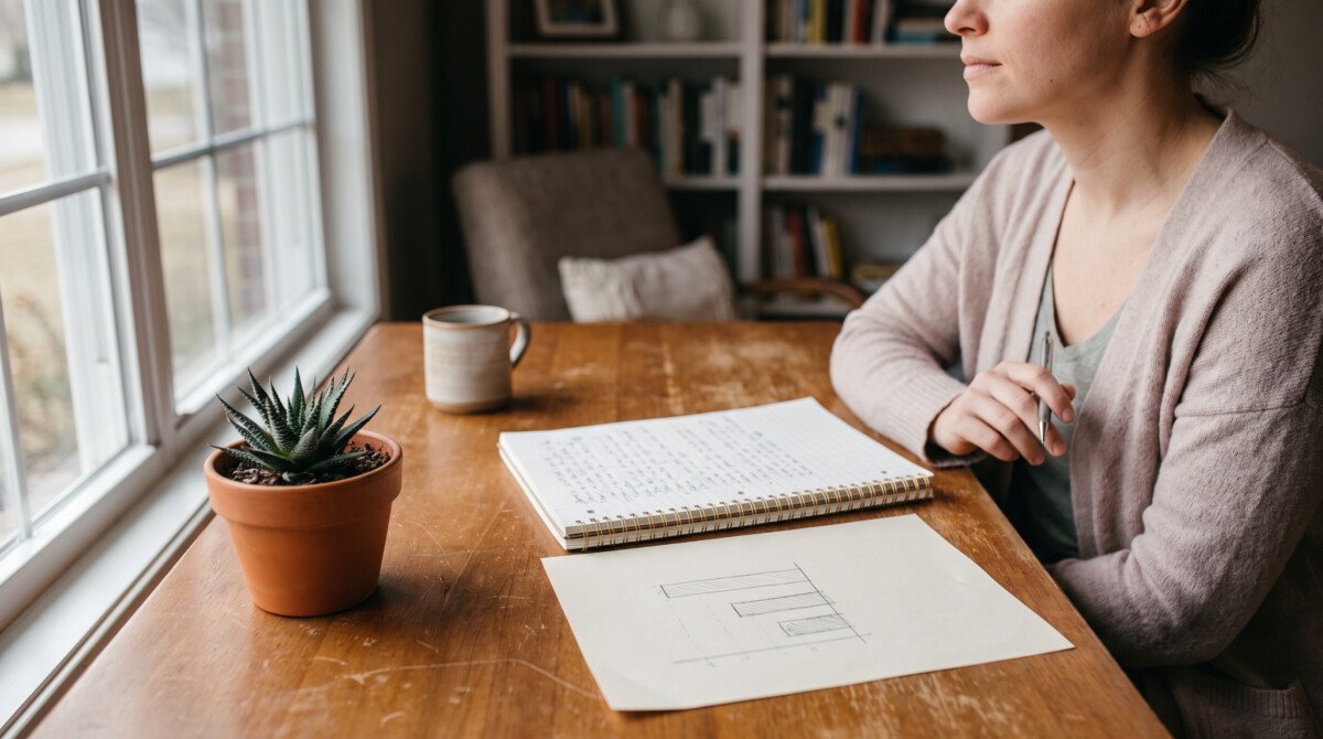 mental accounting bias review process shown through a home workspace with a notebook and hand-drawn savings chart