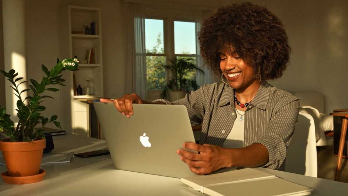 freelancer closing laptop at the end of the day in a home office