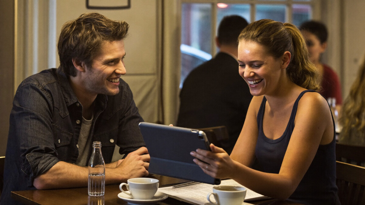 Two friends discussing the three-fund portfolio strategy over coffee