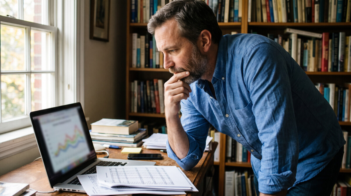 how to rebalance your portfolio without triggering unnecessary taxes — man reviewing brokerage statements at home desk
